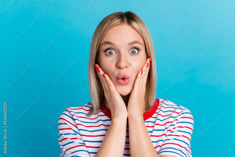 Close-up portrait of young surprised woman with opened mouth standing with palms isolated on blue background Close-up portrait of young surprised woman with opened mouth standing with palms isolated on blue background