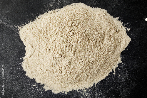 black salt Kala namak finely ground scattered on a black background