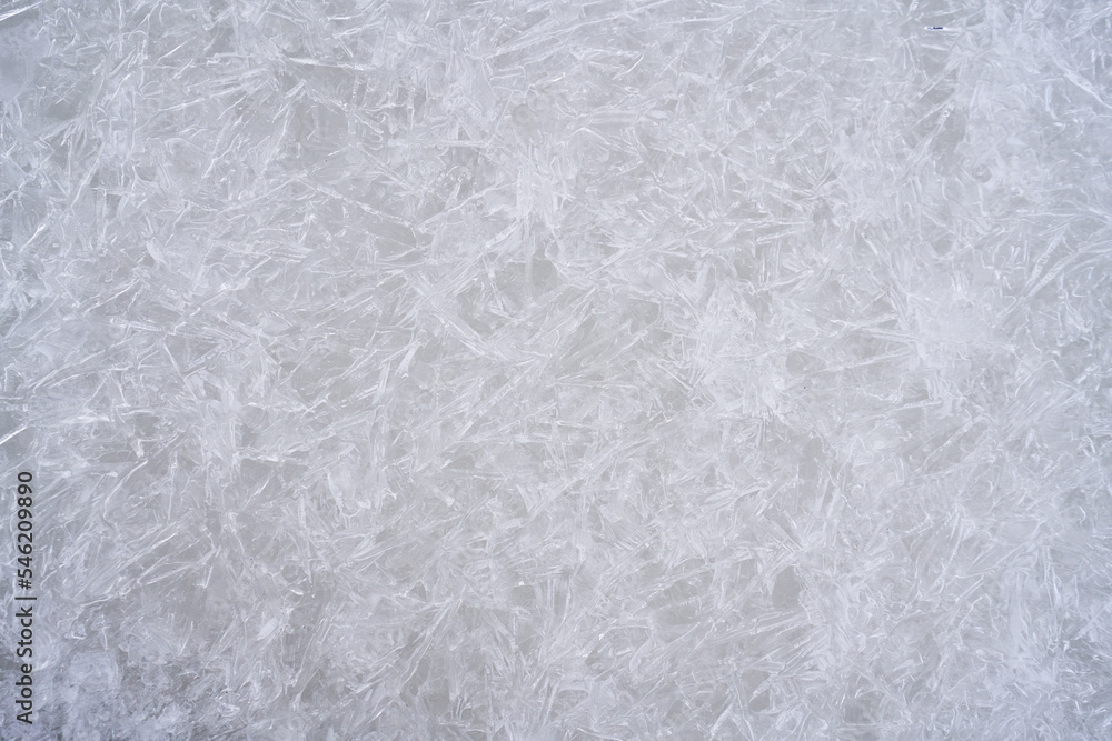 Fresh ice surface texture. Winter background with frozen snowflakes and snow mounds. Fresh ice surface texture. Winter background with frozen snowflakes and snow mounds.