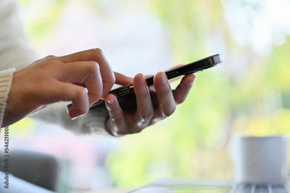 Close-up shot, A female hands holding her smartphone, typing on screen