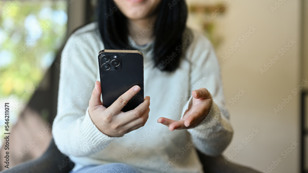 A young Asian woman using her smartphone. cropped image A young Asian woman using her smartphone. cropped image