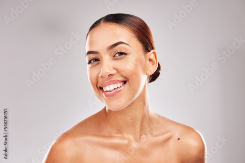 Skincare, wellness and portrait of latino woman with smile on gray background in studio. Beauty, dermatology and face of confident young model for healthy skin, makeup and cosmetic beauty products