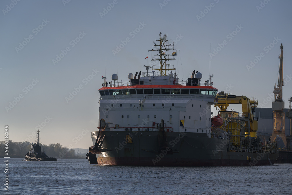 MARITIME ENGINEERING - Cable laying vessel is sailing along the port channel to the sea