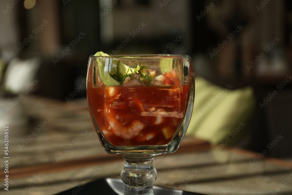 Delicious campechana cocktail with shrimps on table, closeup