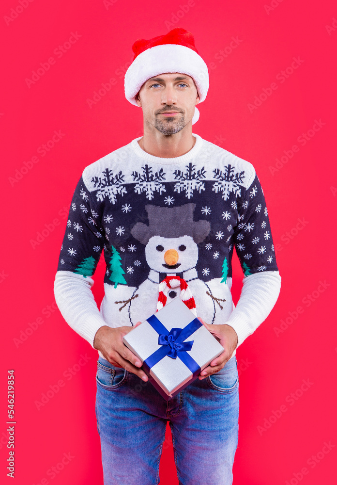 xmas man isolated on red background. man hold present for xmas in studio. xmas present and man