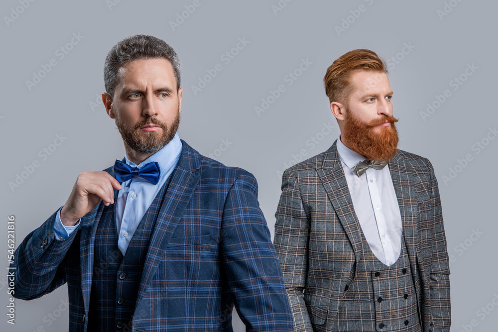 studio shot of caucasian men wearing bowtie and tuxedo. elegant men in formal tuxedo suit studio shot of caucasian men wearing bowtie and tuxedo. elegant men in formal tuxedo suit