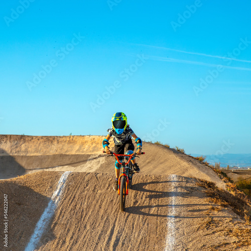 young boy riding with bmx