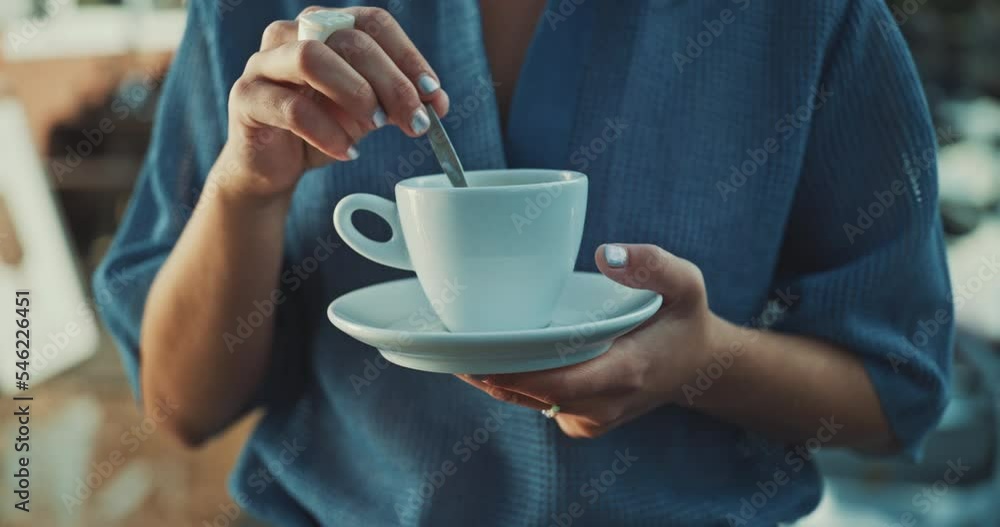 Hands of a young woman stirring coffee Hands of a young woman stirring coffee