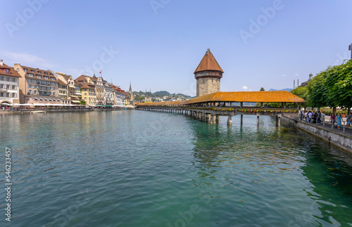 LUCERNE, SWITZERLAND, JUNE 21, 2022 - View of the wodden covered Kapellbrücke Bridge on the Reuss river in Lucerne, Switzerland