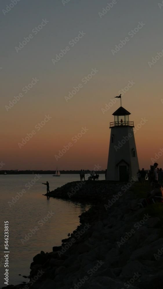 Steady, vertical shot of a lighthouse at sunset Steady, vertical shot of a lighthouse at sunset