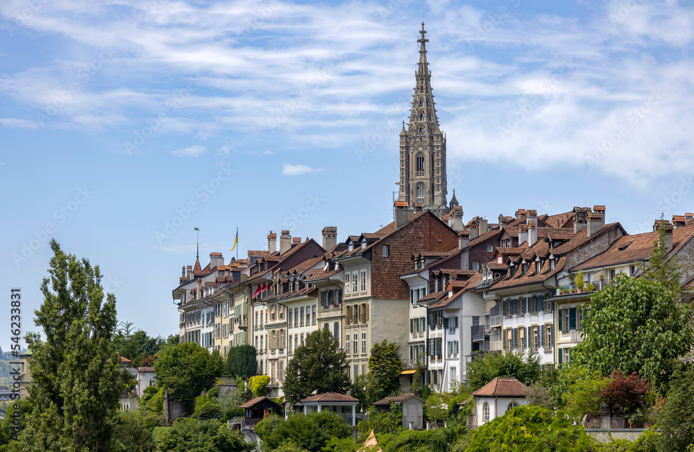 BERN, SWITZERLAND, JUNE 23, 2022 - View of the old buildings and the bell tower of the Bern's Cathedral in the center of Bern, Switzerland