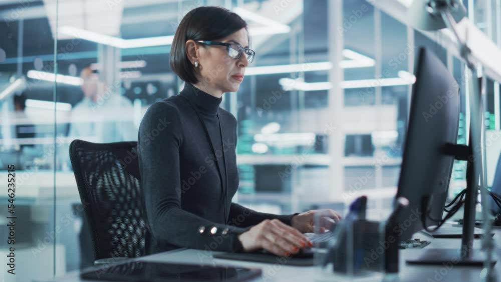 Adult Female Industrial Engineer Developing 3D Model of a Circuit Motherboard on Computer CAD Software in a Startup Facility. Modern Technological Research and Development Center.