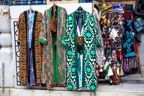 Uzbek traditional clothes such as robes and other colorful souvenirs, Tashkent, Uzbekistan. 