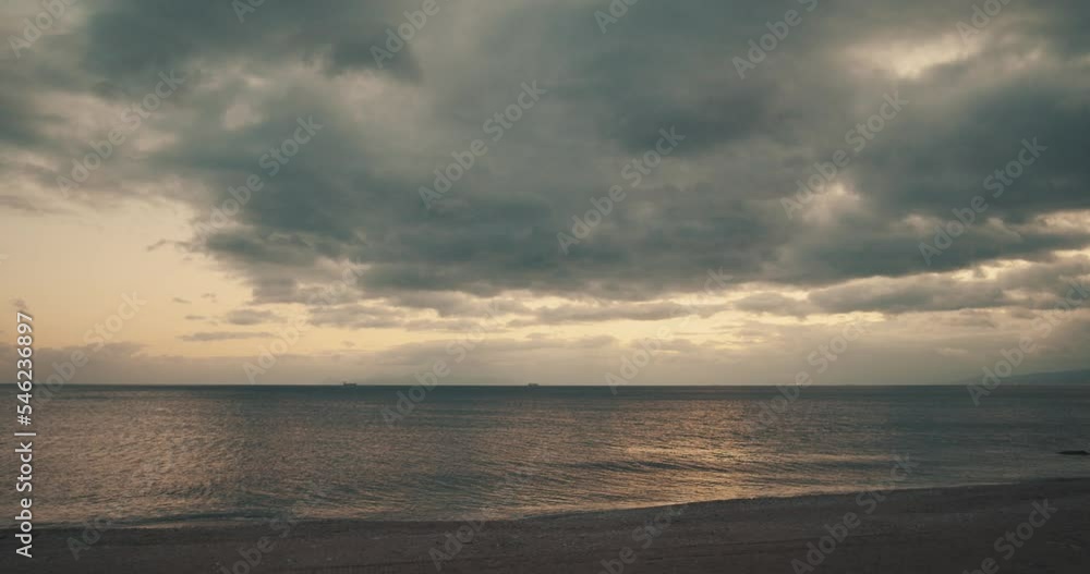 Cinematic view of beach and cloudy sky at sunset. Cinematic view of beach and cloudy sky at sunset.