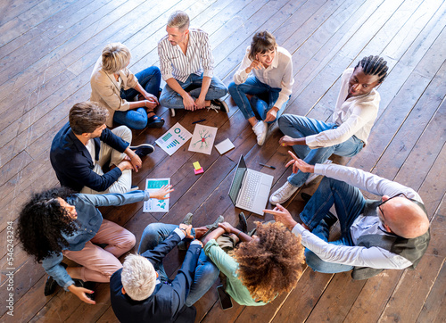 Creative business people having a team building session, mixed age range group of designer working together for strategy, teamwork brainstorming