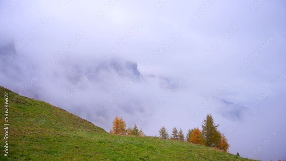 Mountains and forest in Alps, Italian Dolomites filmed in cloudy and fogy weather. Filmed with a gimbal from right to left movement in a wide view in 4k. With fog moving in the air Mountains and forest in Alps, Italian Dolomites filmed in cloudy and fogy weather. Filmed with a gimbal from right to left movement in a wide view in 4k. With fog moving in the air