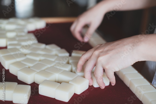 Hands arranging, playing Mahjong game. Concept of chinese leisure games traditional, family activity, Hongkong board game, chinese new year fmily time entertainment. Lucky game. photo