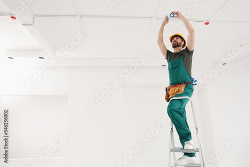 Electrician fixing wires with insulating tape indoors
