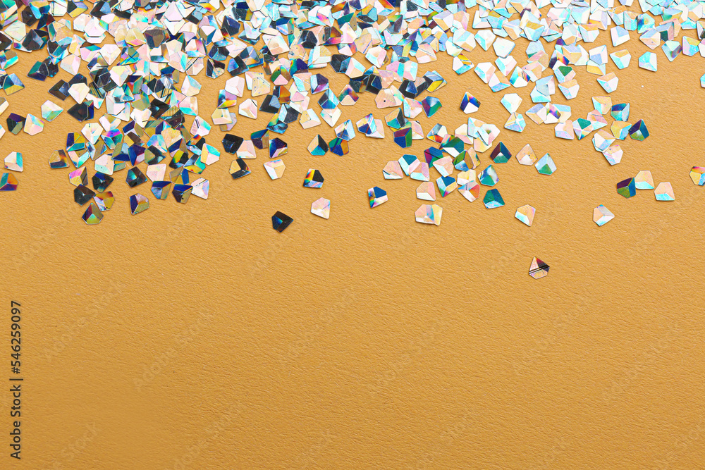 Shiny bright glitter on beige background. Space for text Shiny bright glitter on beige background. Space for text