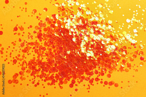 Shiny bright glitter on orange background, flat lay © New Africa