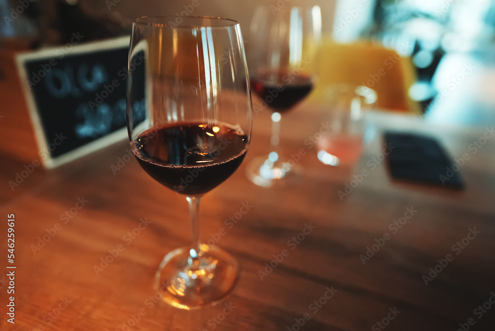 Glass of red wine is on the table. Wine degustation. Glass of red wine is on the table. Wine degustation.