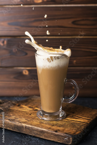 coffee latte in a glass on wooden board