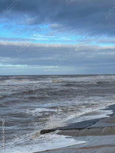 Waves crashing onto the beach and sea wall during high tide. Taken in Cleveleys Lancashire England. 