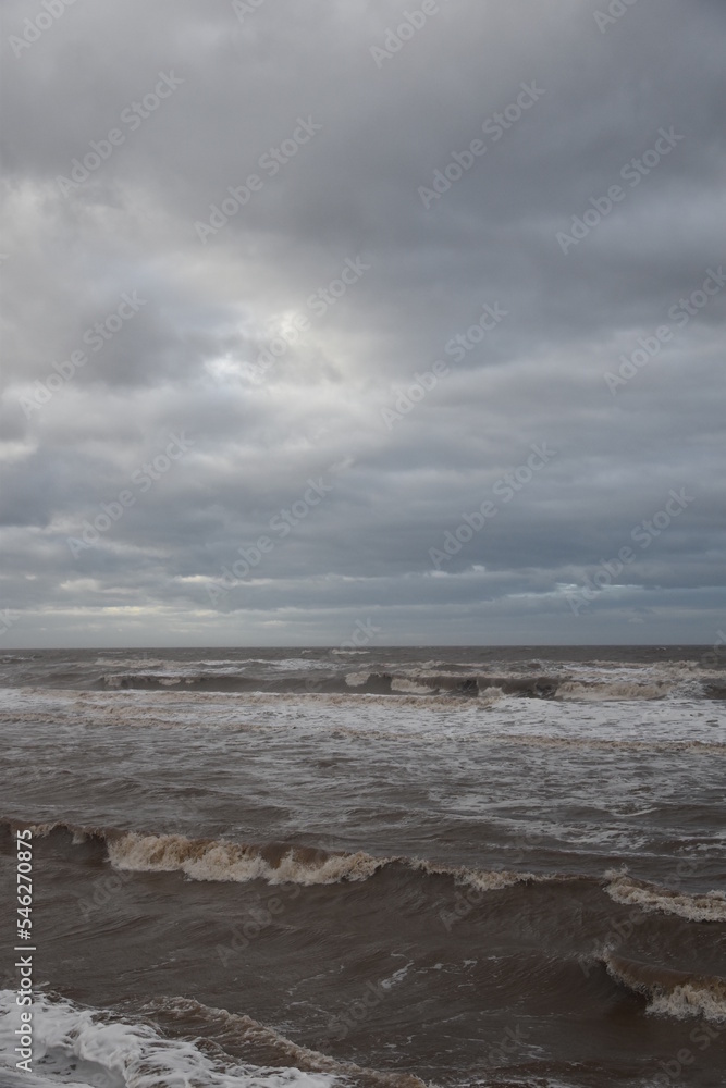 Waves crashing onto the beach and sea wall during high tide. Taken in Cleveleys Lancashire England. Waves crashing onto the beach and sea wall during high tide. Taken in Cleveleys Lancashire England.