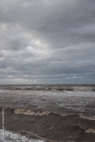Waves crashing onto the beach and sea wall during high tide. Taken in Cleveleys Lancashire England. 