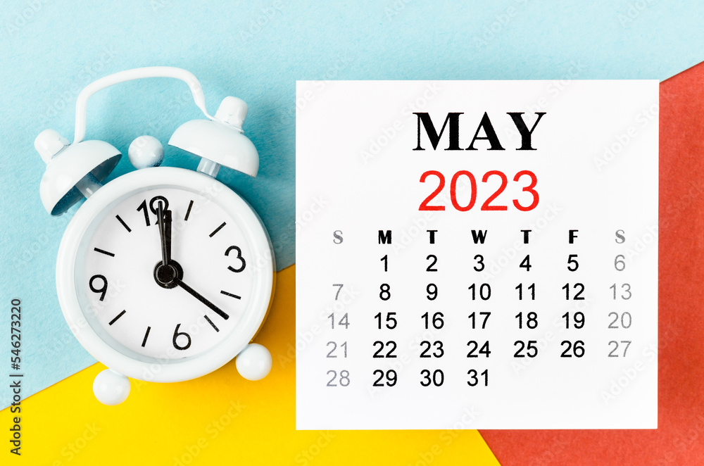 The May 2023 Monthly calendar year with alarm clock on colourful background. The May 2023 Monthly calendar year with alarm clock on colourful background.
