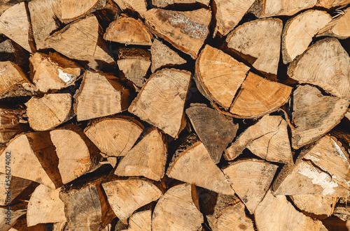 Finely chopped and stacked firewood. Stacks of Firewood. Preparation of firewood for the winter. Firewood background.