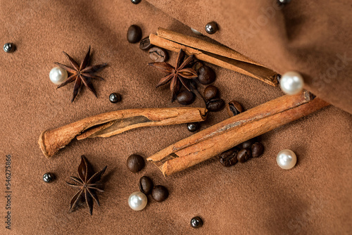 Wallpaper Mural An elegant composition of spices - with anise, cinnamon on a suede brown background with beads and pearls Torontodigital.ca