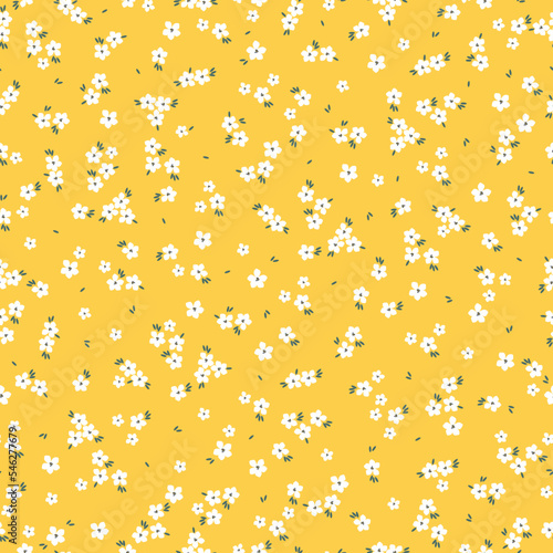 Cute floral pattern. Seamless vector texture. An elegant template for fashionable prints. Print with small white flowers, green leaves. yellow background.