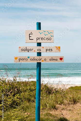 São Francisco do Sul, Santa Catarina, Brasil: placa de madeira com frase na praia brava photo