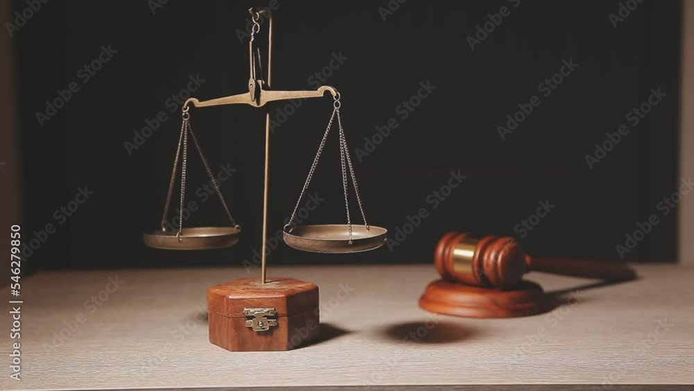 Justice and law concept.Male judge in a courtroom with the gavel, working with, computer and docking keyboard, eyeglasses, on table in morning light Justice and law concept.Male judge in a courtroom with the gavel, working with, computer and docking keyboard, eyeglasses, on table in morning light