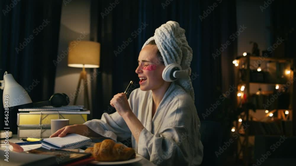 Positive lady singing dancing home workplace closeup. Smiling woman making notes Positive lady singing dancing home workplace closeup. Smiling woman making notes
