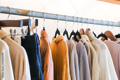 Clothes hanging on rack in fashion store.