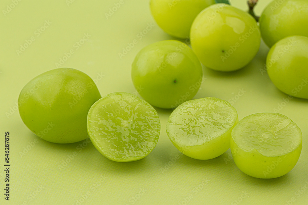 A bunch of Shine Muscat green grape on green background