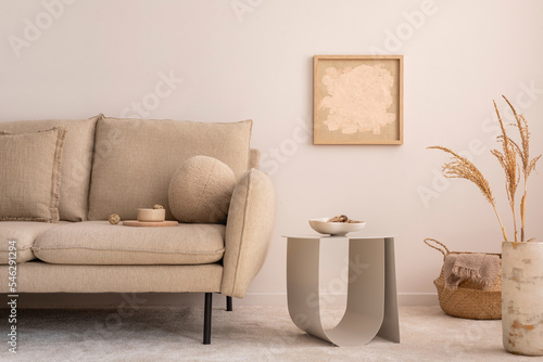 Interior design of cozy living room with mock up poster frame elegant beige sofa  modern coffee table  vase with dried flowers  basket  plaid and stylish personal accessories. Home decor. Template.