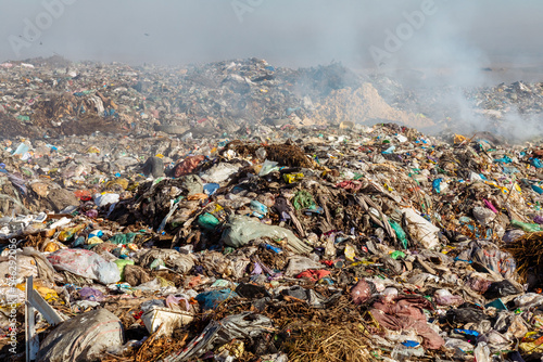 Closeup of burning trash piles in landfill