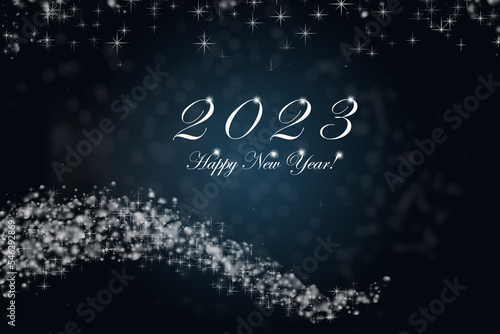 Happy New Year 2023. Sparkling burning numbers Year 2023 with stars and bokeh on blue background.