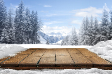 Desk of free space cover of snow flakes and winter landscape. 