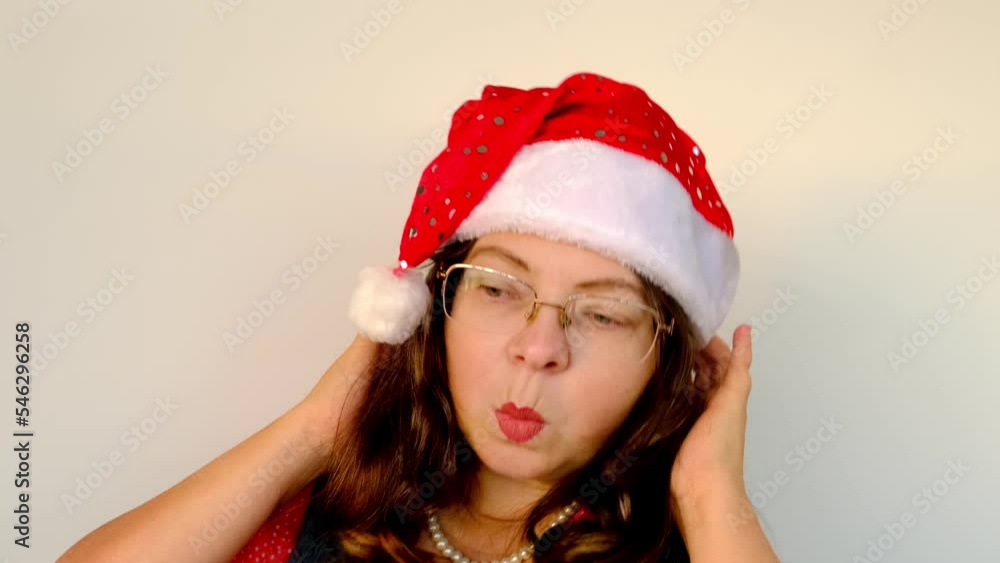 close-up of cheerful adult woman in santa claus red hat with long hair, having fun, festive mood, congratulations, good wishes, christmas concept, waiting for gifts, new year celebration close-up of cheerful adult woman in santa claus red hat with long hair, having fun, festive mood, congratulations, good wishes, christmas concept, waiting for gifts, new year celebration