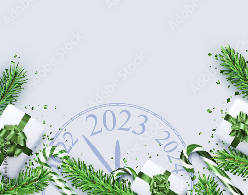 Christmas flatlay composition with clock 2023, gift box, candy cane, confetti, fir branch.