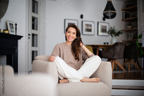 Obraz na plátně Attractive and smiling woman portrait while relaxing in her beautiful home