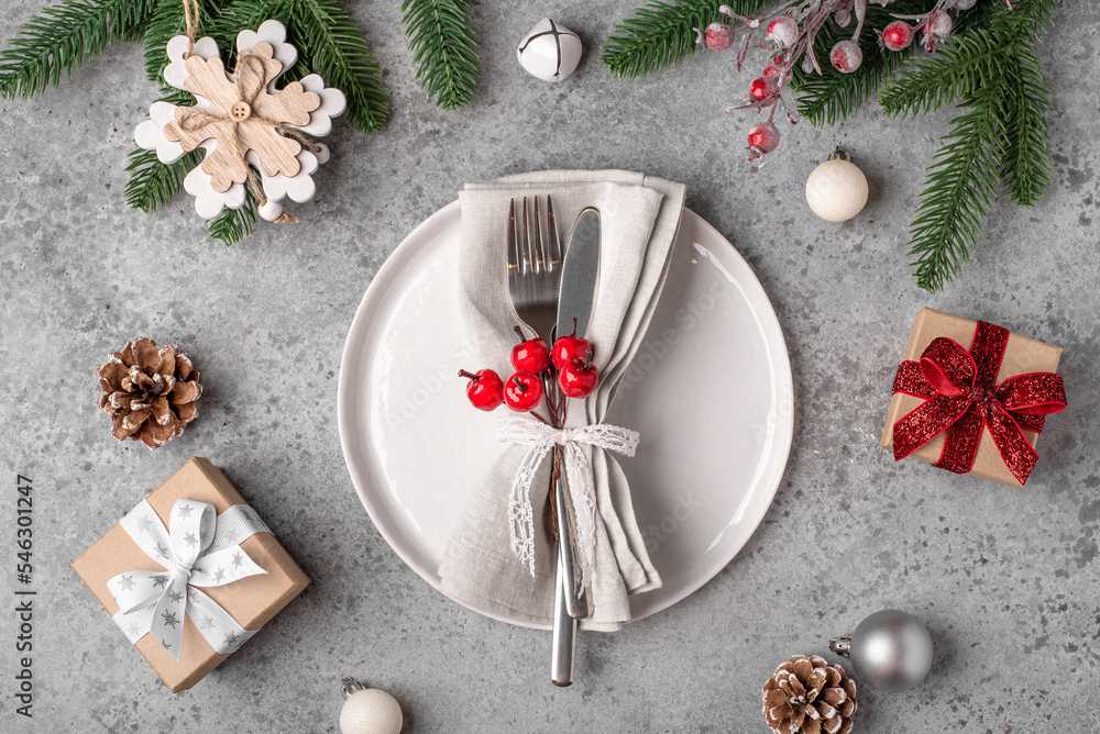 Christmas place setting and decorations on gray table. Christmas place setting and decorations on gray table.
