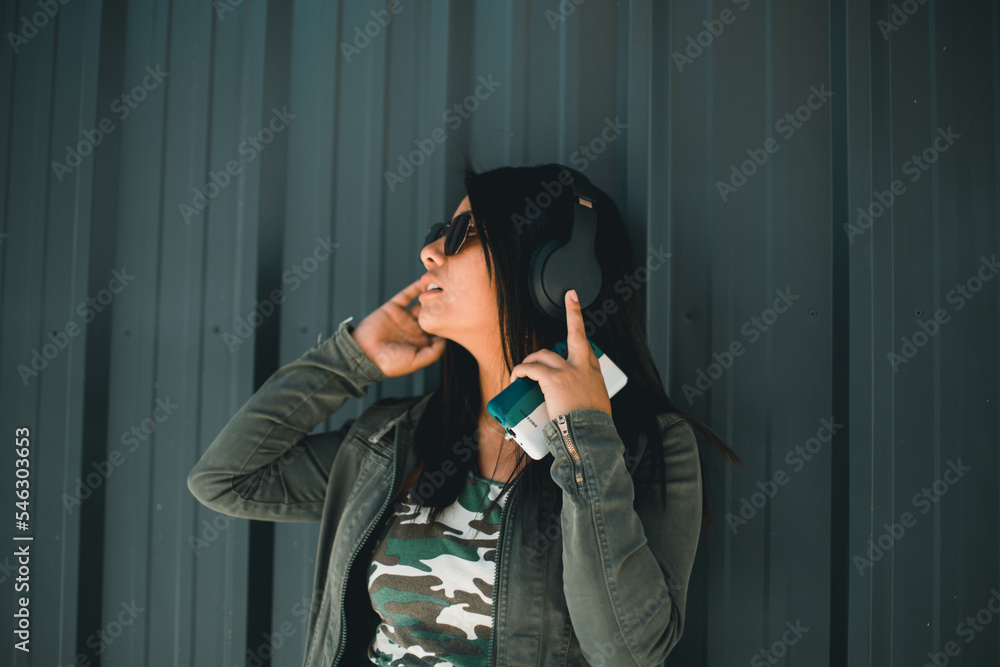 latina woman enjoying music with wireless headphones. Concept of technology, mental health, and lifestyle.