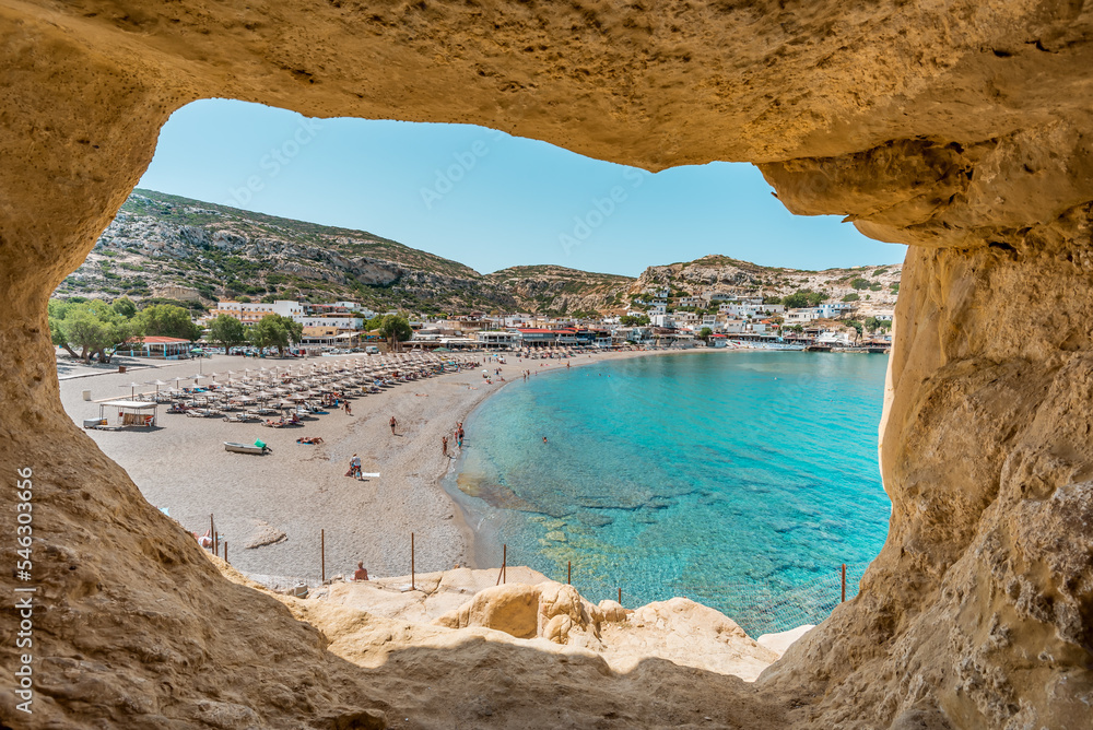 matala beach, crete island, greece: sceniv view from famous caves to the beautiful coast and village
