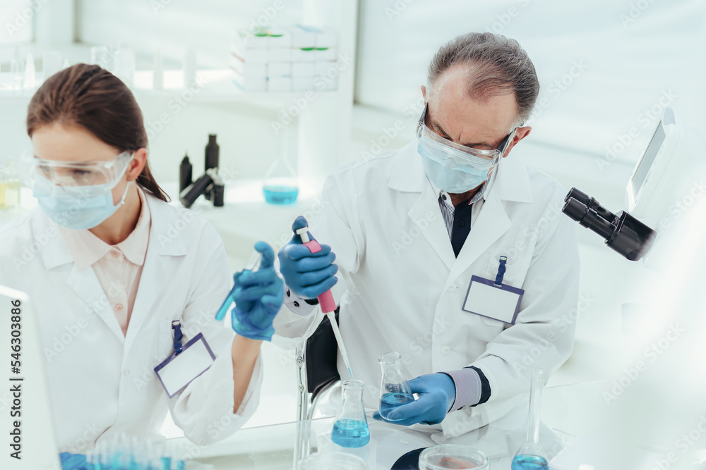 close up. female scientist with a test tube in her hands. close up. female scientist with a test tube in her hands.