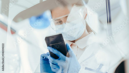 Obraz na płótnie bottom view. female scientist looking at the screen of her smartphone. w salonie